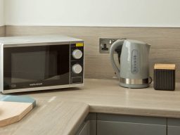 Microwave and kettle on a kitchen countertop.